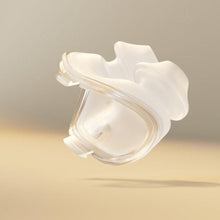 Load image into Gallery viewer, A translucent white sleep mask with a clear nose bridge, floating in mid-air against a soft beige background.
